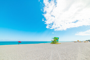 Fototapeta premium Huge cloud over a colorful lifeguard tower in Miami Beach