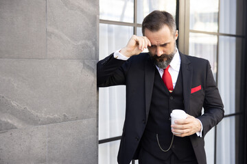 Businessman in Suit Holding a Cup of Coffee with Depression