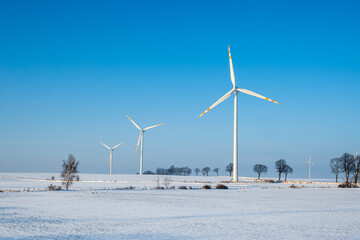 Windmills for electric power production. Winter landscape in northern Poland. Europe © vivoo