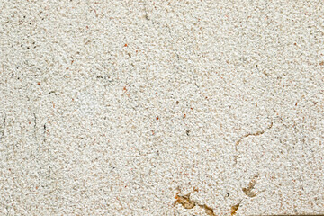 Apply sand rubbing plaster to masonry on concrete. Scratched and cracked dirty weathered sand textured plaster surface texture.