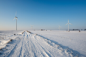 Snow covered field road. Winter landscape in northern Poland. Europe