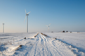 Fototapeta na wymiar Snow covered field road. Winter landscape in northern Poland. Europe