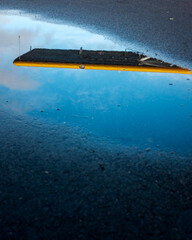 The reflection of a seaplane in a puddle on a blue sky day