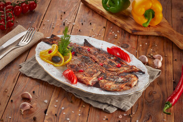 Grilled dorado fish with lemon, wooden background