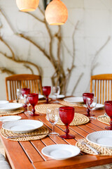 Red glasses on the terrace table in the evening