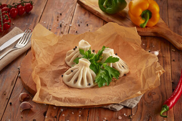 Khinkali with meat, Georgian cuisine, wooden background