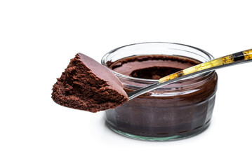 Dark chocolate mousse with ganache in glass jar isolated on white