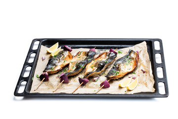 Baked mackerel and red onion on skewers on baking tray