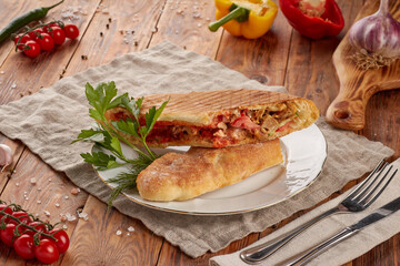 Doner kebab with meat, vegetables and sauce, wooden background