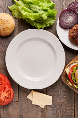 empty plate and ingredients for burger