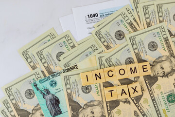 IRS form 1040 with individual income tax return of dollar bills of Stimulus economic tax return check