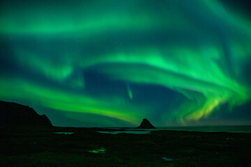 Fototapeta na wymiar strong northern lights (aurora borealis) in the norwegian wilderness