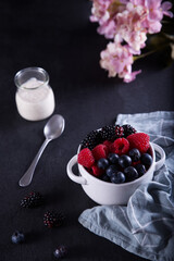 Healthy diet with red fruits such as blackberries, blueberries, raspberries and yogurt.