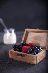Healthy diet with red fruits such as blackberries, blueberries, raspberries and yogurt.