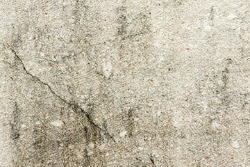 Apply sand rubbing plaster to masonry on concrete. Scratched and cracked dirty weathered sand textured plaster surface texture.