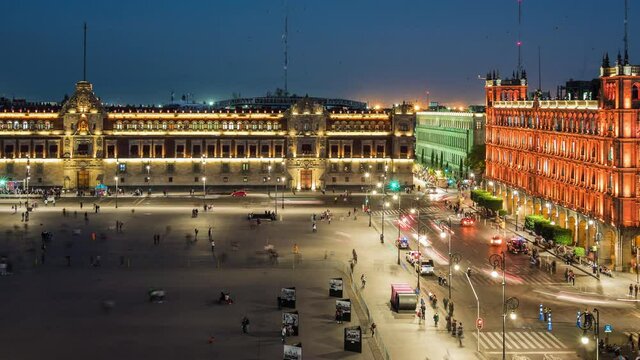 Zoom out time lapse view of people and traffic around historical landmarks Zocalo Square (Spanish: Plaza del Zocalo ) and National Palace in the Historic Center of Mexico City, Mexico.