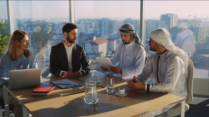 International meeting of arabian and european investors negotiating partnership agreement rreading contract together inside office cabinet. Business people.