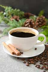 Obraz na płótnie Canvas Tasty coffee with cinnamon in cup on gray background