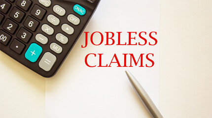 Jobless Claims , form on white background with calculator and pen and white background.