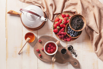 Composition with cup of hot fruit tea on wooden background