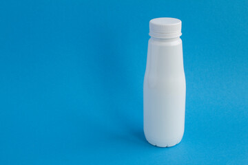 Closeup on white plastic bottle on the blue  background