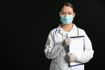 Portrait of female Asian doctor with clipboard on dark background