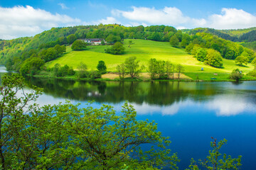 Rursee at Eifel National Park, Germany. Scenic view of lake Rursee and surrounded green hills in North Rhine-Westphalia