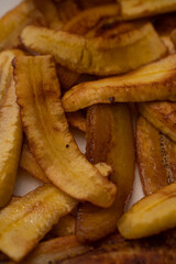 Sliced fried plantains to make a typical Venezuelan dish with arepas and shredded meat, Pabellón...