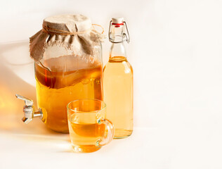 Kombucha drink.Drink from fermented tea in a bottle.Natural organic lemonade from tea on a white background