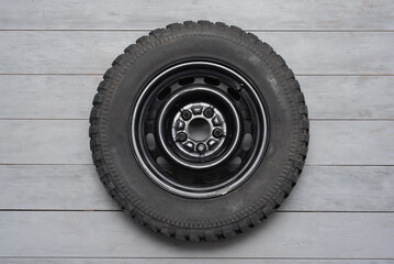 Off road mud terrain wheel on the gray flat lay background.