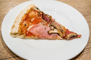 Delicious classic italian Pizza Carbonara with ham, tomatoes, mushrooms and cheese