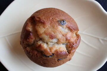 A blueberry muffin on a plate - top view