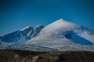 Mountain Snøhetta covered in snow in Norway