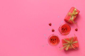 Glasses of wine and gifts for Valentine's Day on color background