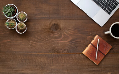 .Laptop, coffee, pen and notebook on old wooden table with copy space.