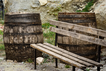 Bench against the background of oak barrels near the walls of the temple