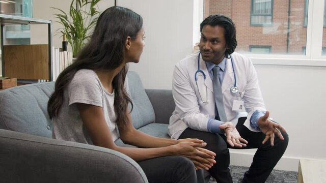 Doctor Explaining Difficult News to Young Woman