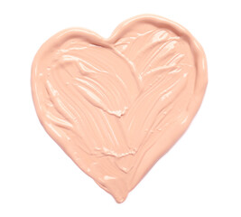 Heart made of makeup foundation on white background