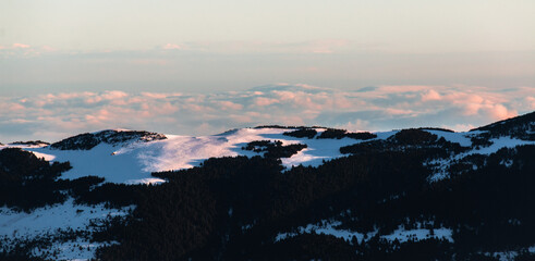 Snowy mountain range at sunrise. Calm and relaxing nature mountainous natural scenery. Nature background landscape with clear sky on early morning in the mountains.