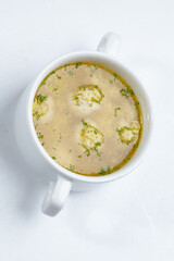 soup with meatballs on white dish