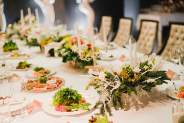 Catering banquet table at wedding reception. Restaurant presentation, european cuisine, food consumption, party concept. Food styling, appetizers bar, welcome drink, event design.
