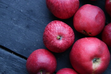 Red fresh and juicy apples on a vintage table.