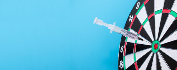 Medical syringe in general for dart throwing. The concept of success in the treatment of diseases, the correct selection of drugs, the success of vaccines and the victory over Covid-19