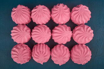 Fruit marshmallow on blue background, close up, flat lay