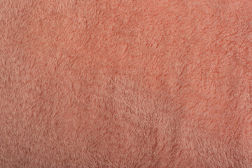 Abstract background of apricot color. Fur textile close up