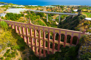 View of restored Eagle Aqueduct (Puente del Aguila) with four levels of arches passing water for local irrigation in Spanish city of Nerja.