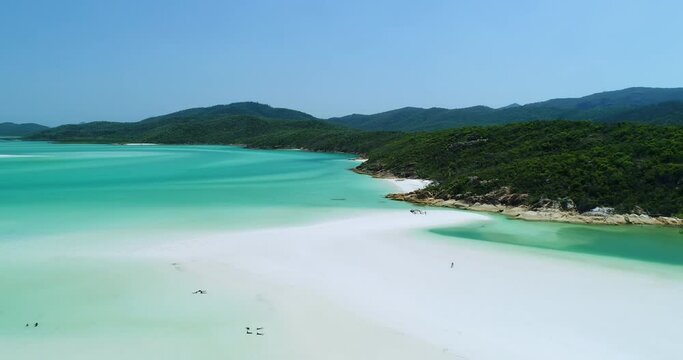 4K aerial reverse tracking low angle motion over the white sands of Hill Inlet at Whitehaven Beach,Whitsundday Islands,Queensland,Australia