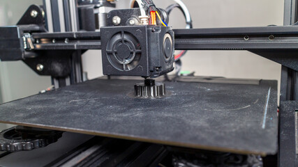 3D plastic printer during work in a factory three dimensional printing. Close-up detail.