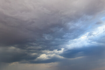 Dark storm clouds in sky before thunderstorm and rain. Dramatic sky background