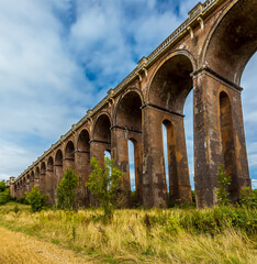 Obraz premium The view northward beside the Ouse Valley viaduct in Sussex, UK on a summers day
